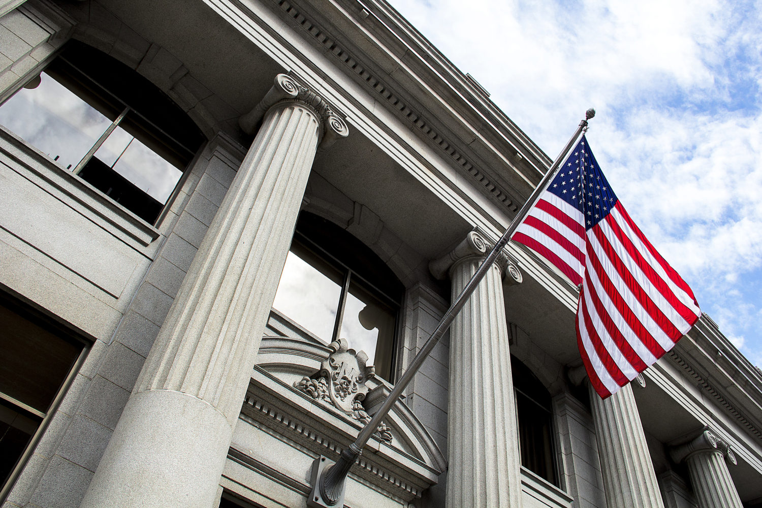 Megan O'Neill and William Delgado named 2026 Lawdragon Leading Litigators of America. Government building. American flag.